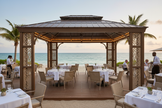 Large custom-sized hardtop gazebo in commercial beachfront restaurant setting